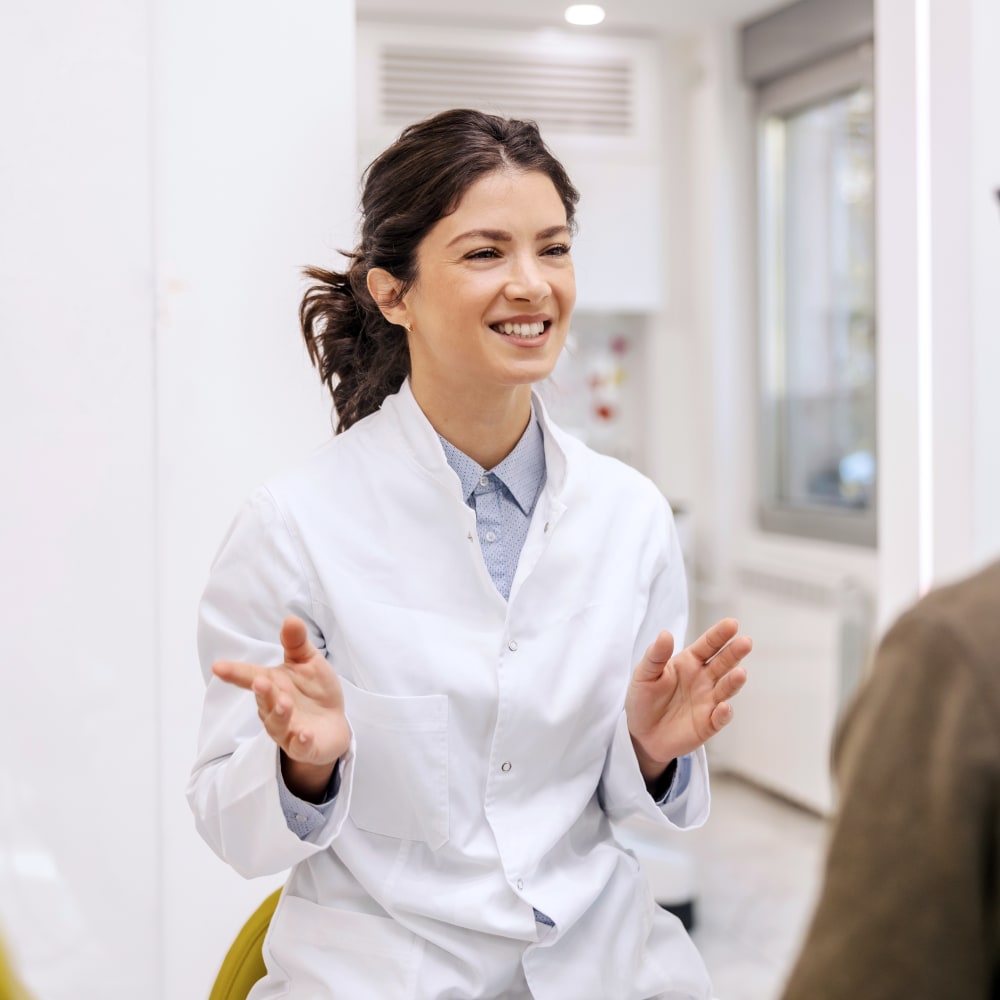 A female dentist is talking to a patient